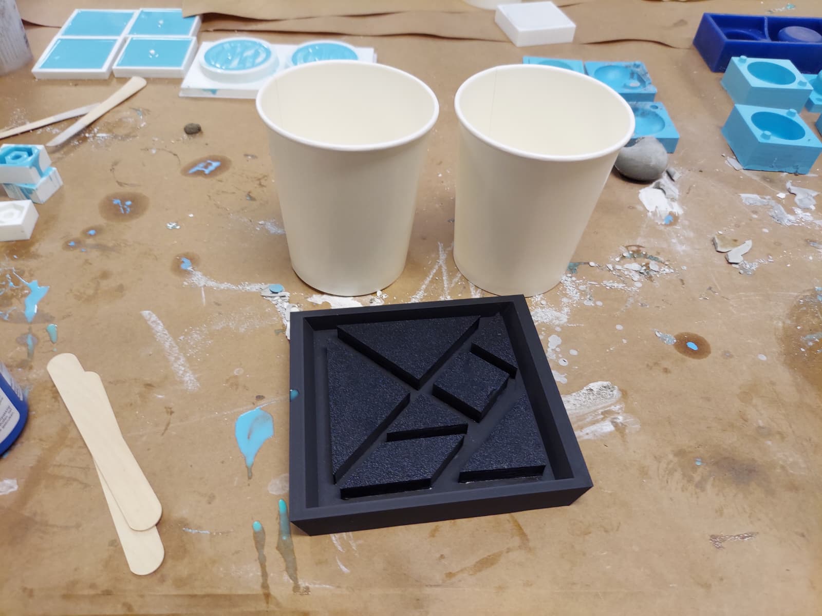 Tangram master plate on table with mixing cups ready